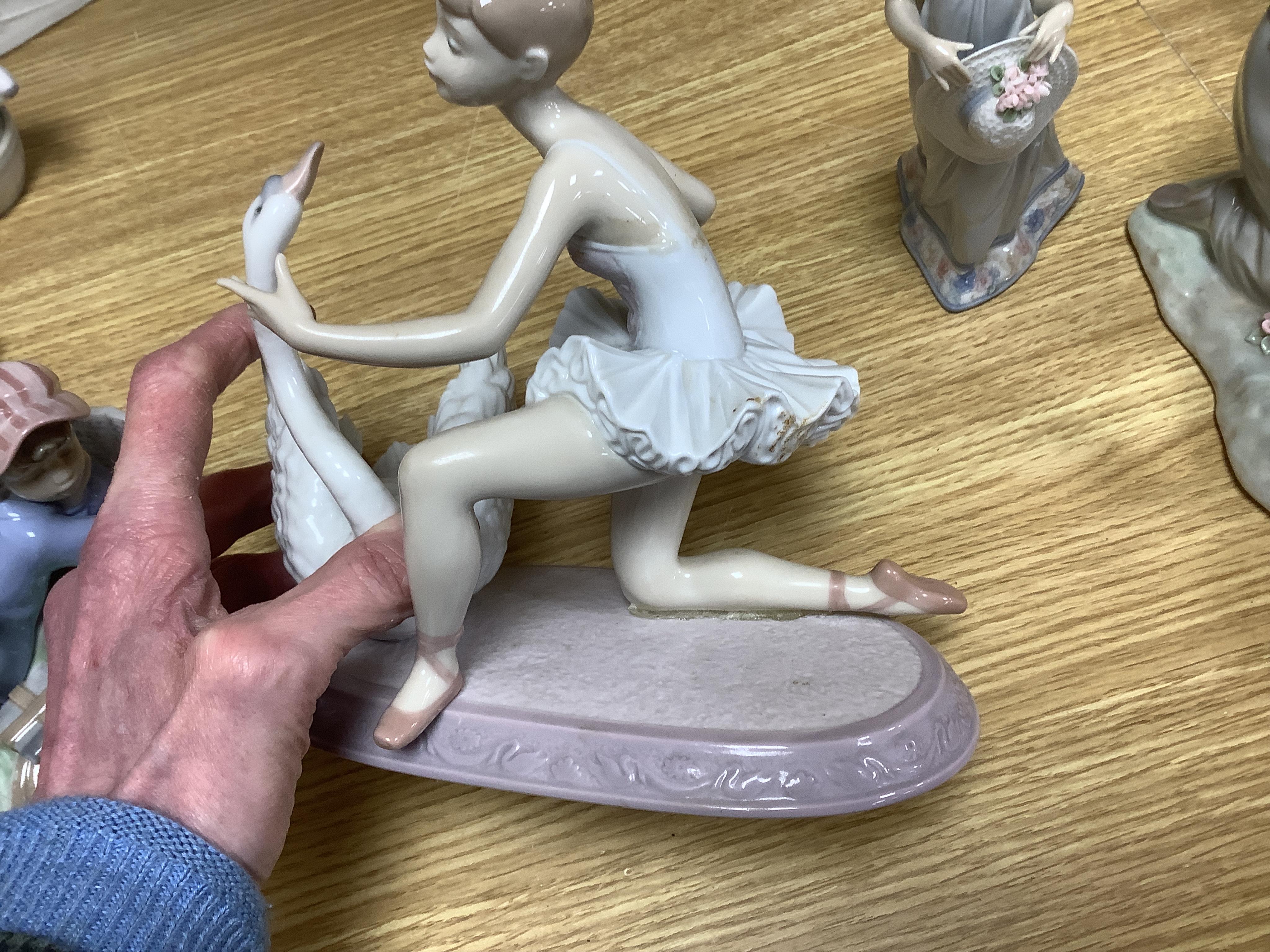 A Lladro fisherman group, nine other Lladro models and two others, similar. Fisherman group 40cm wide. Condition - generally good